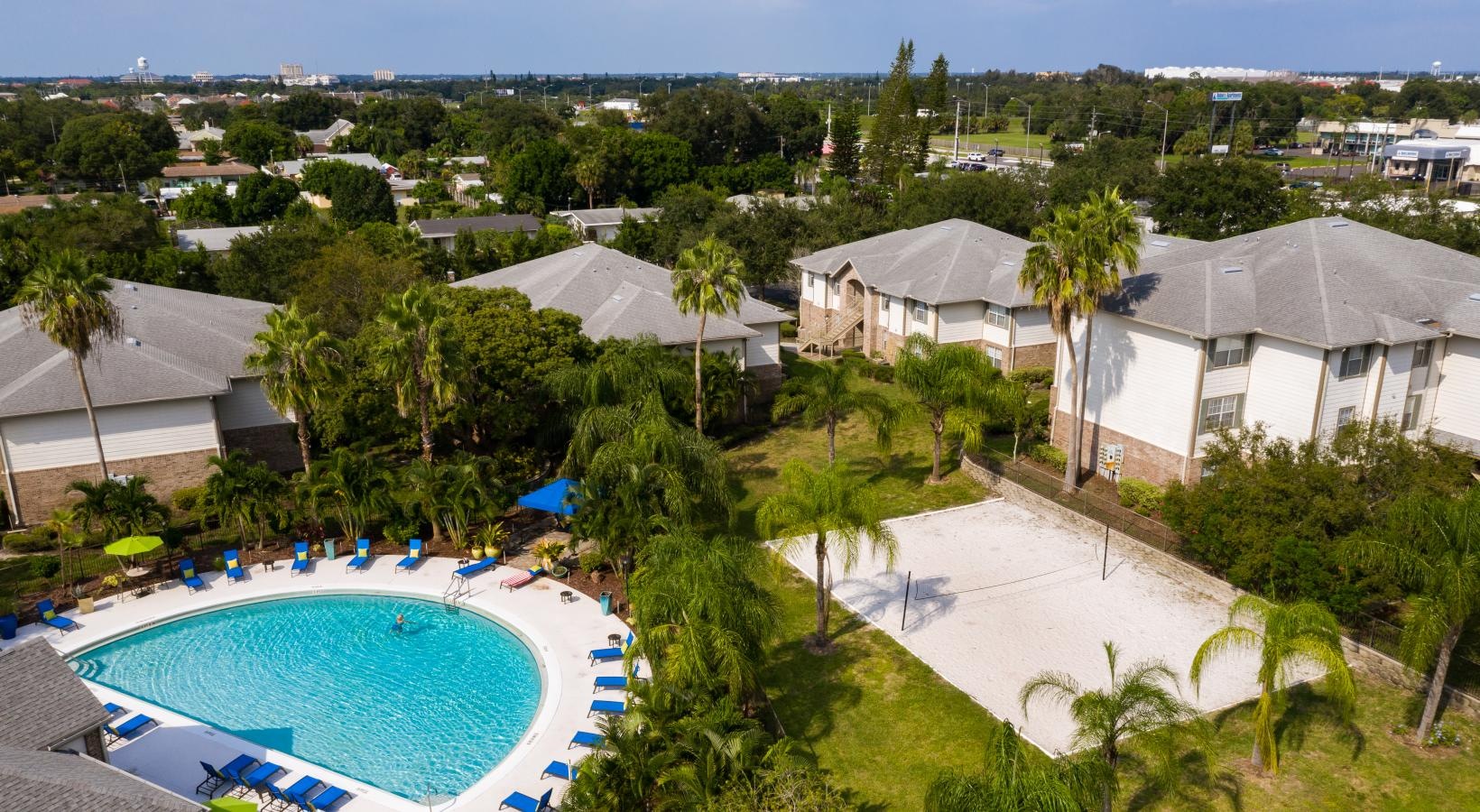 Aerial view of swimming pool next to sand volleyball court