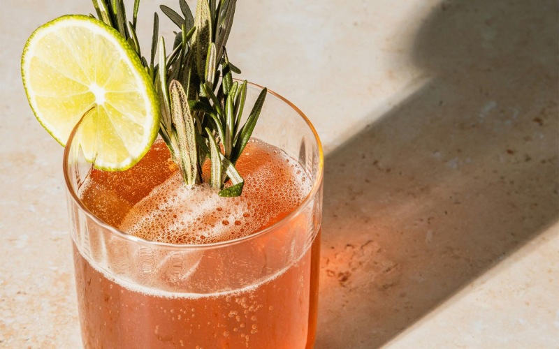 a glass with a drink and a lemon on top