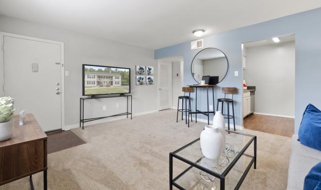 a living room with a table and chairs