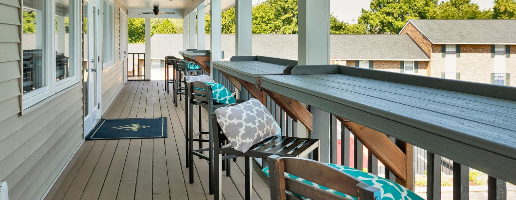 a deck with chairs and tables on it