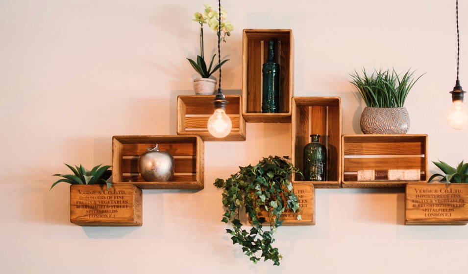 wooden shadow boxes on a wall with decor in and on them