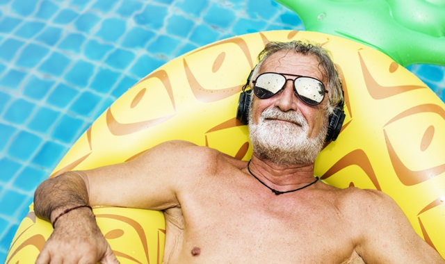 Lifestyle Image Of Man Sunbathing In A Pool