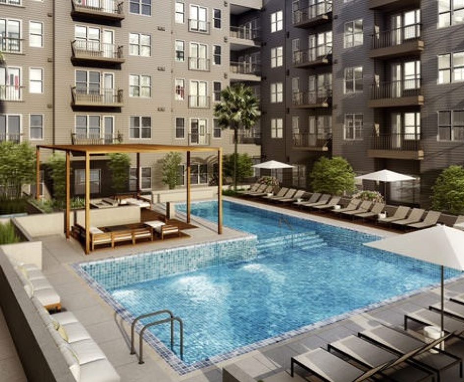 lounge chairs in swimming pool rest on tanning deck with fountains