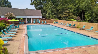 Swimming pool area with lounge chairs and umbrellas