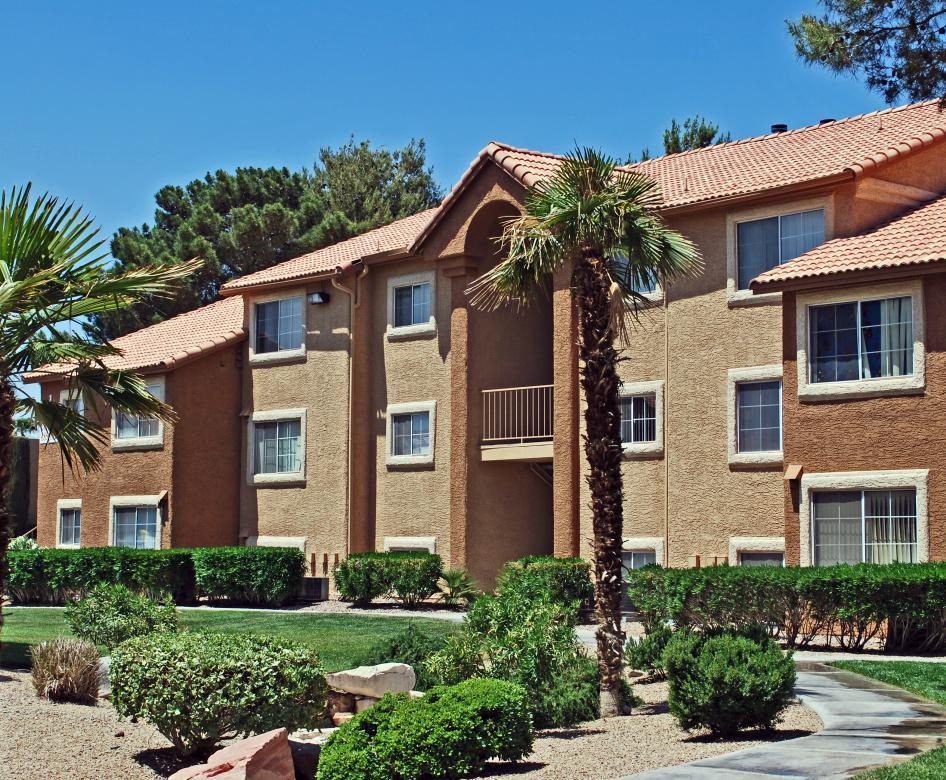 a large building with palm trees