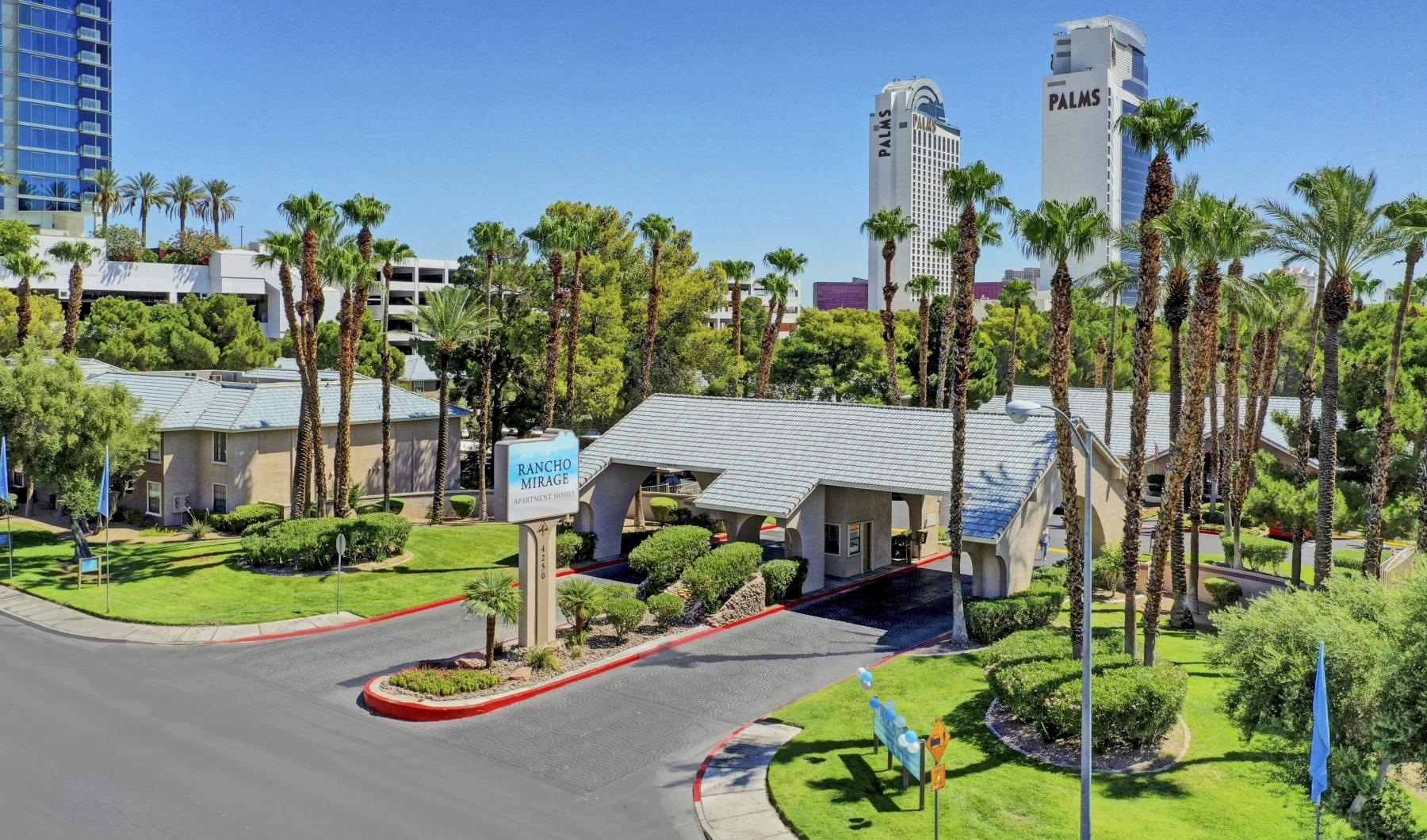 a road with palm trees and buildings