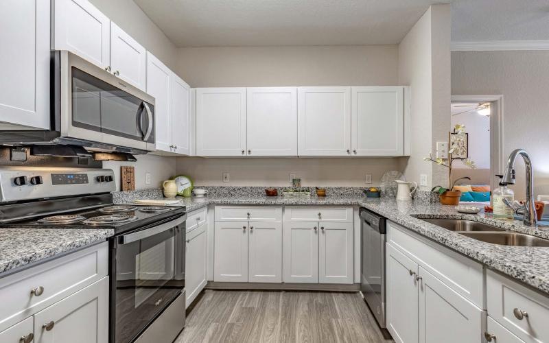 a kitchen with white cabinets