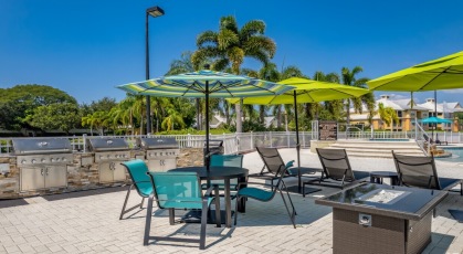 Grill area with umbrella shaded tables and chairs