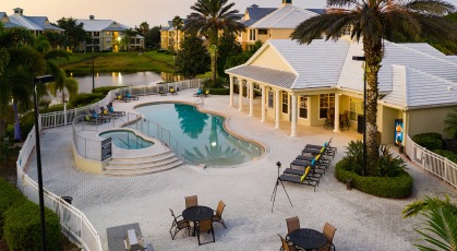 Aerial view of pool and jacuzzi with grilling area with lounge seating