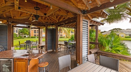 Outdoor dining pavilion with kitchen and lake side views