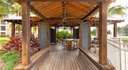 Outdoor dining pavilion with kitchen and lake side views