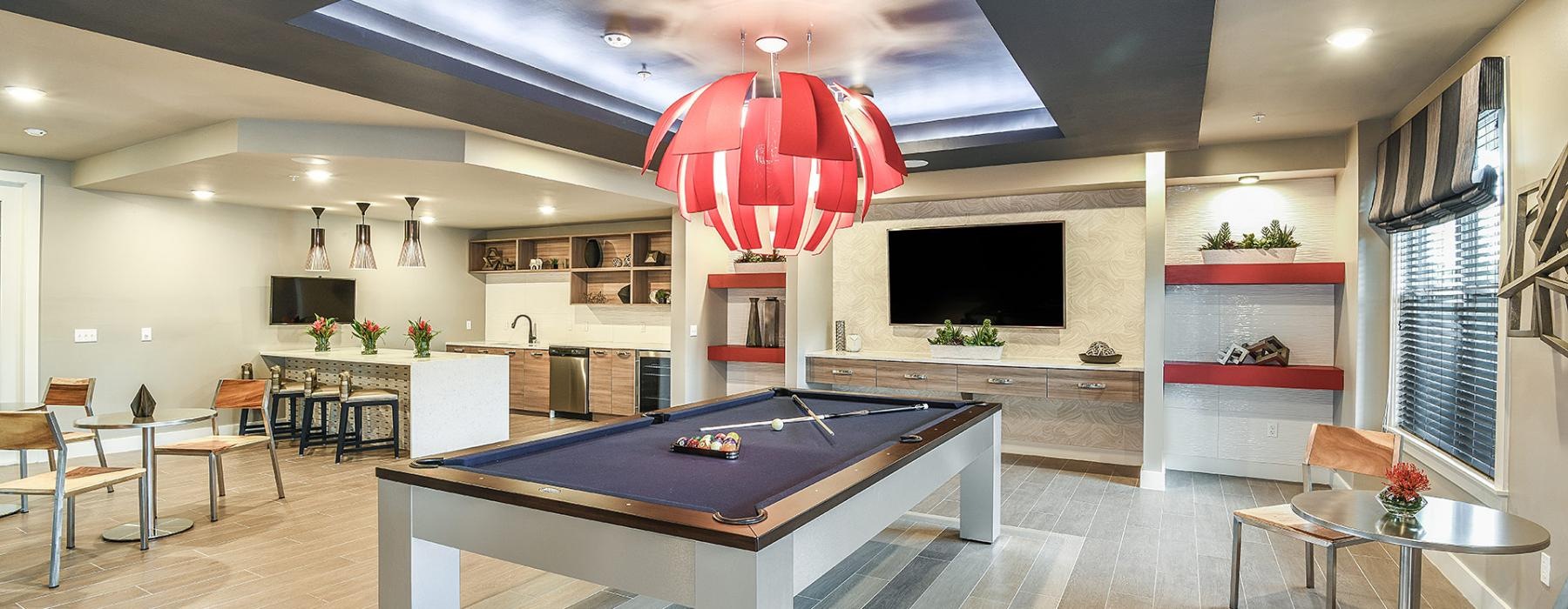 a room with a pool table and seating options