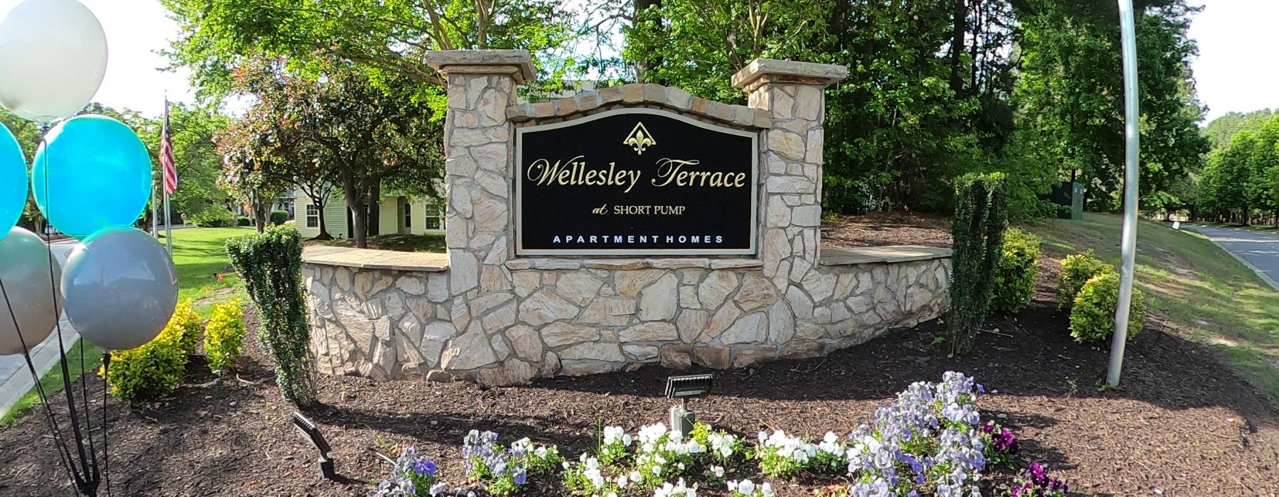 a sign on a stone wall