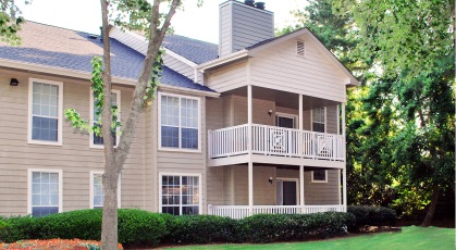 Complex exterior building facing well manicured lawn and landscaped grounds