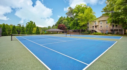 Two fenced in, outdoor tennis courts