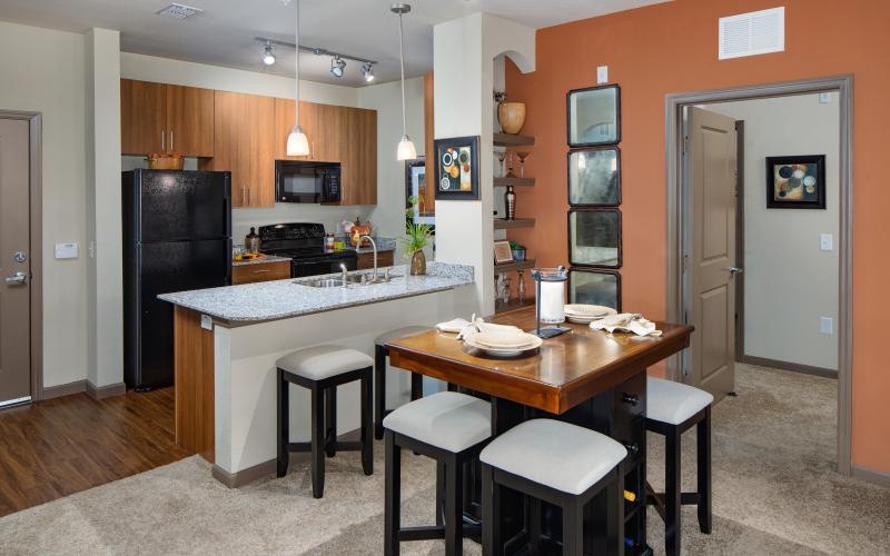 a kitchen with an island bar and stools