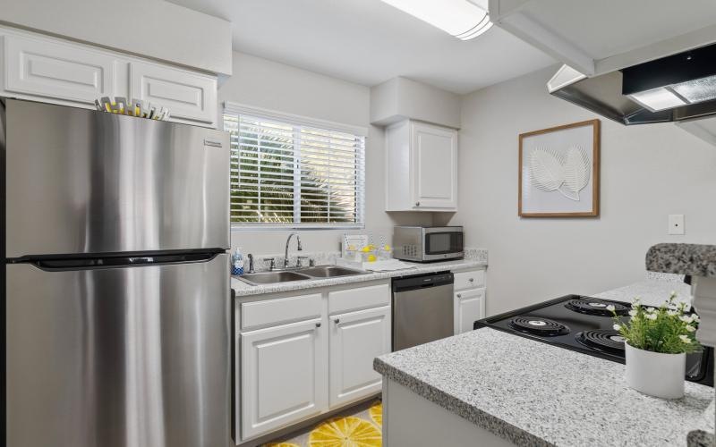 a kitchen with white cabinets