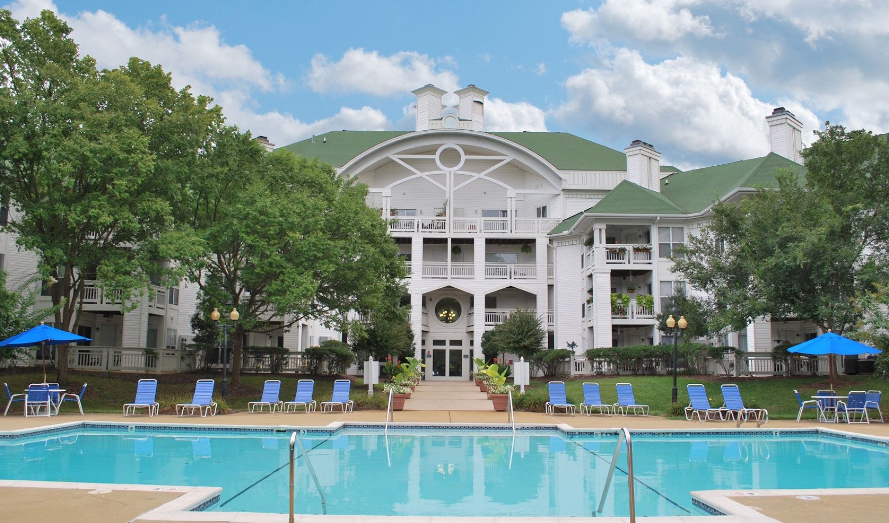 a swimming pool in front of a large building