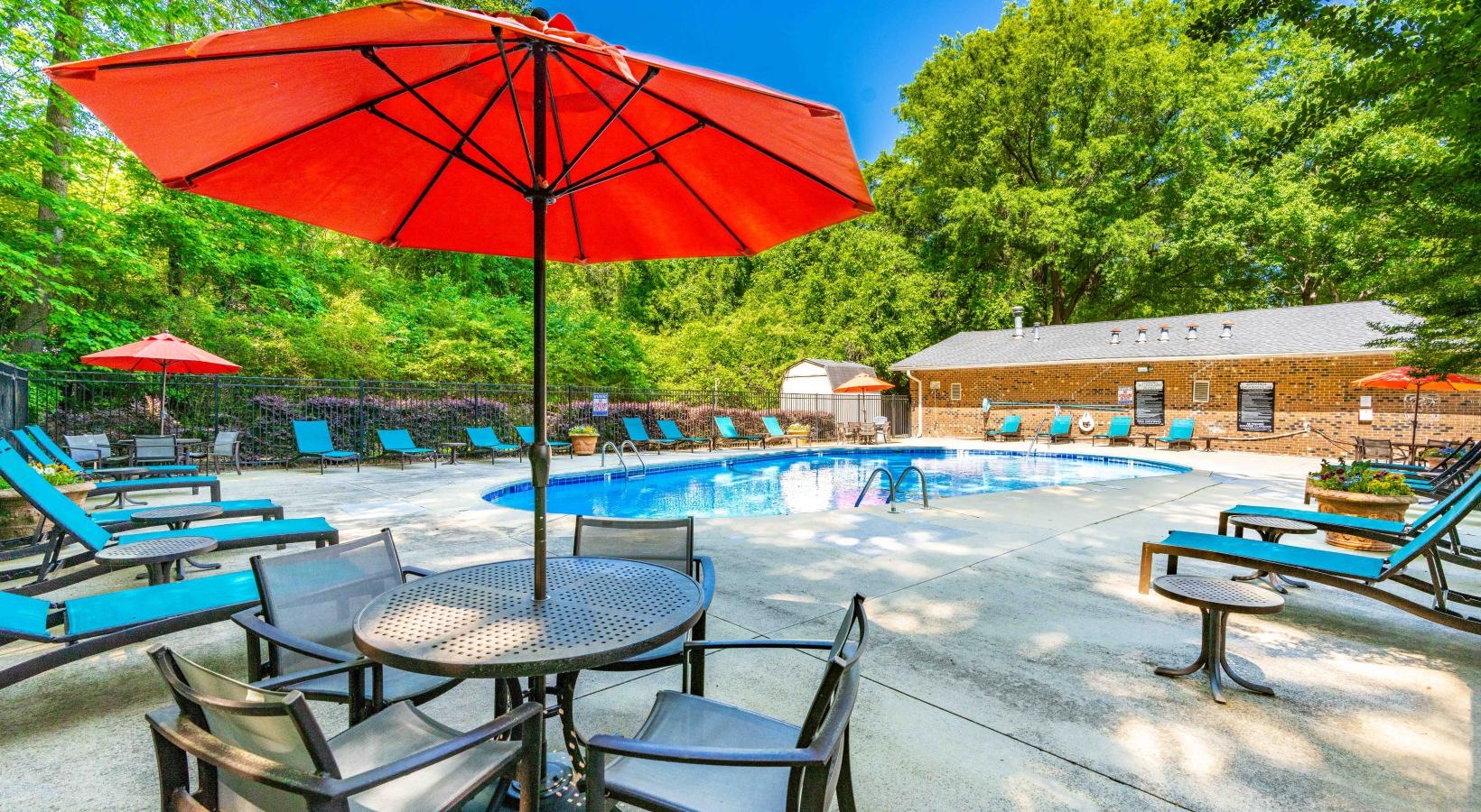 Swimming pool with lounge seating and umbrellas