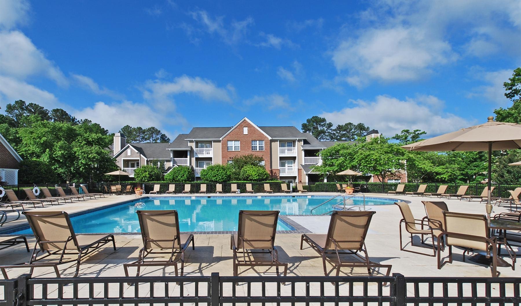 a pool with lounge chairs around it