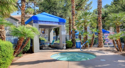 Tropical, outdoor spa next to covered social area