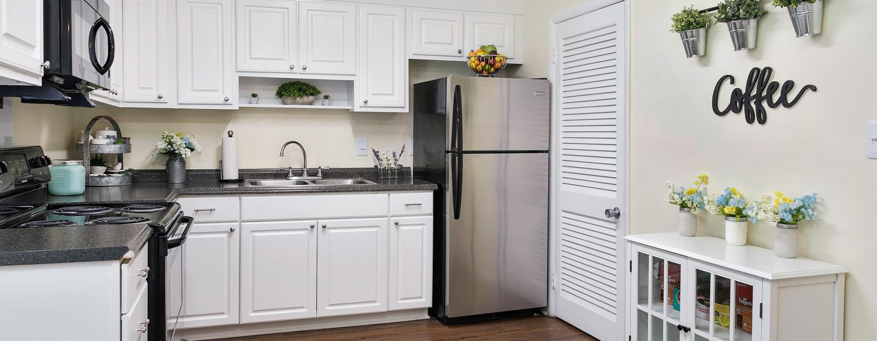 a kitchen with white cabinets