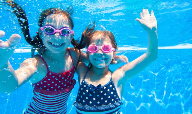 children having underwater fun in pool