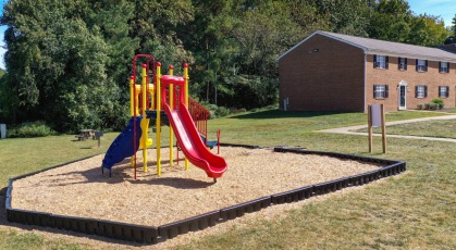 Brightly colored playground in a mulch bed  at London Towne