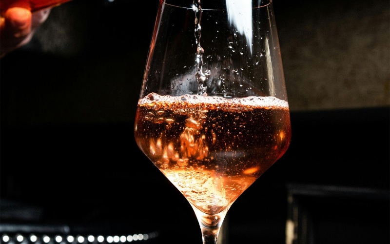 a glass of wine being poured