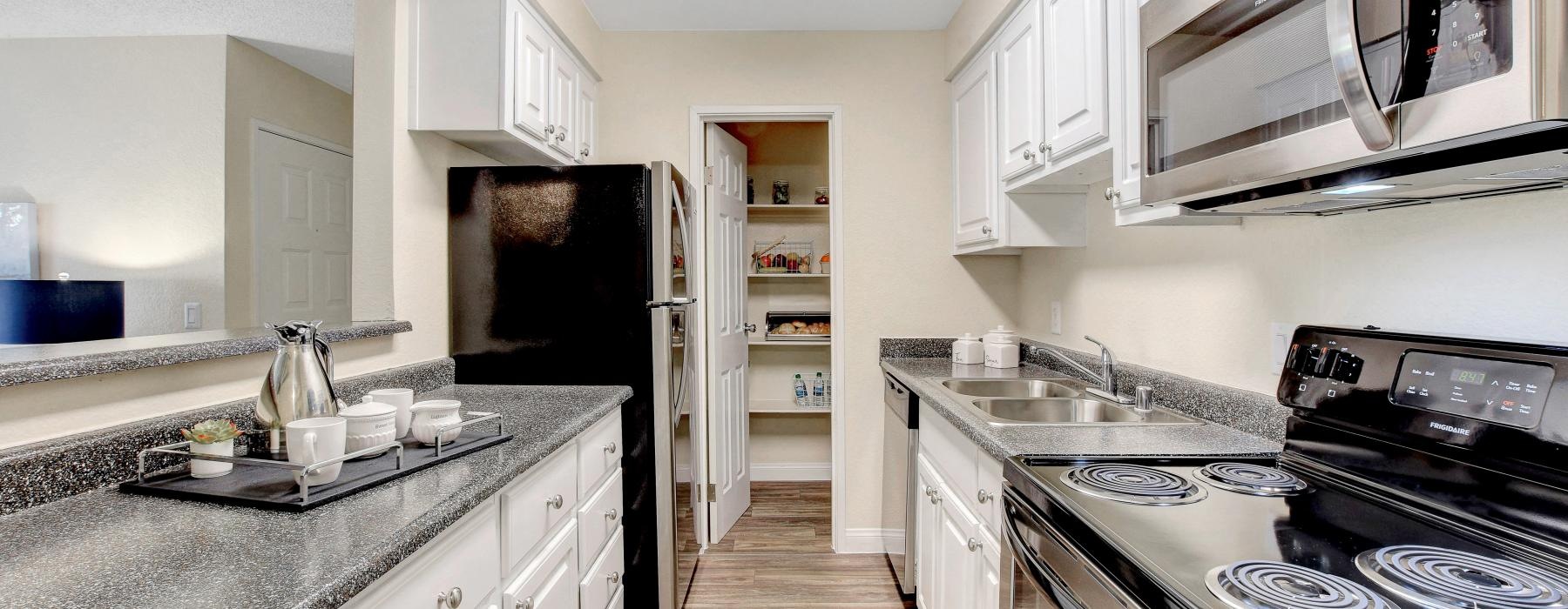 a kitchen with white cabinets