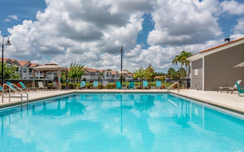 a swimming pool with lounge chairs