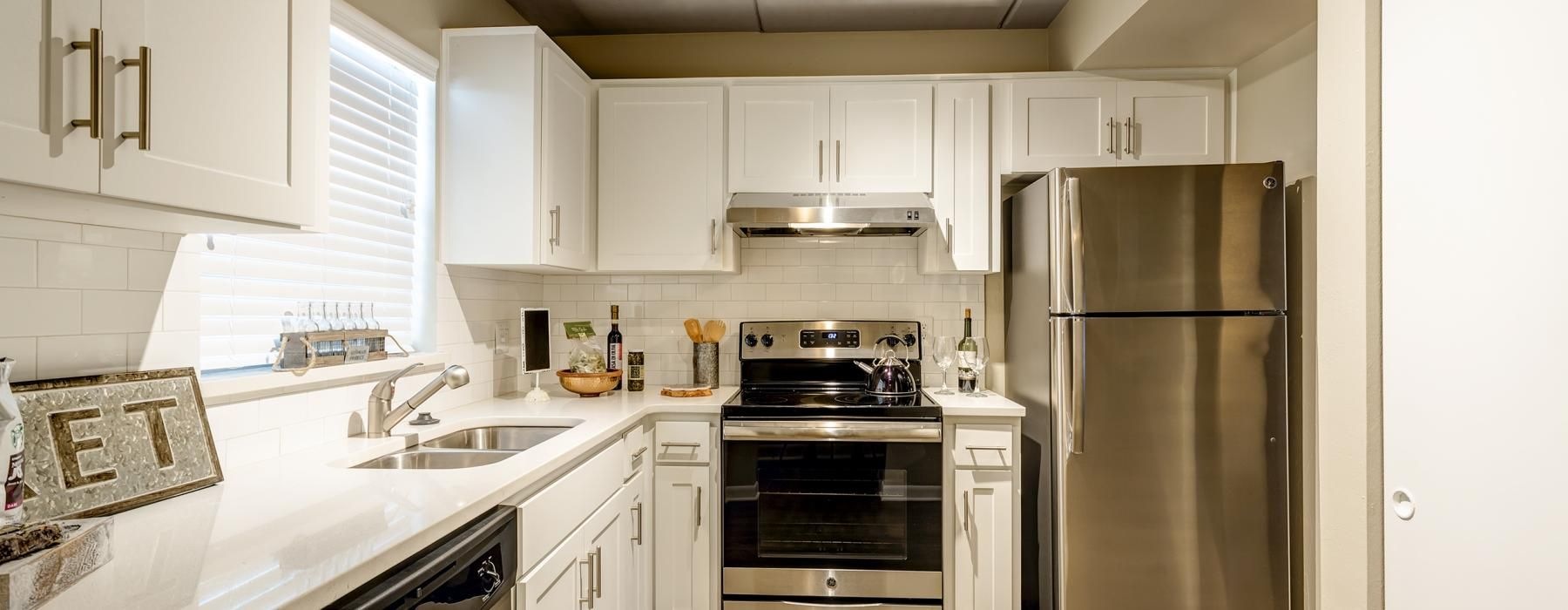 a kitchen with white cabinets