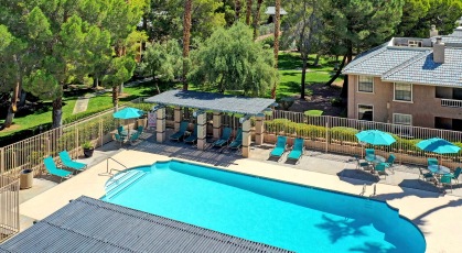 Sparkling swimming pool with lounge seating and umbrellas