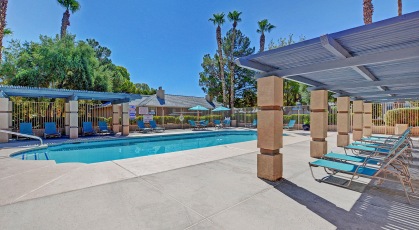 Sparkling swimming pool with lounge seating and pergola