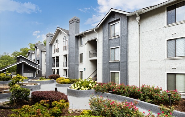 exterior of three-story apartments overlooking landscaped courtyard area