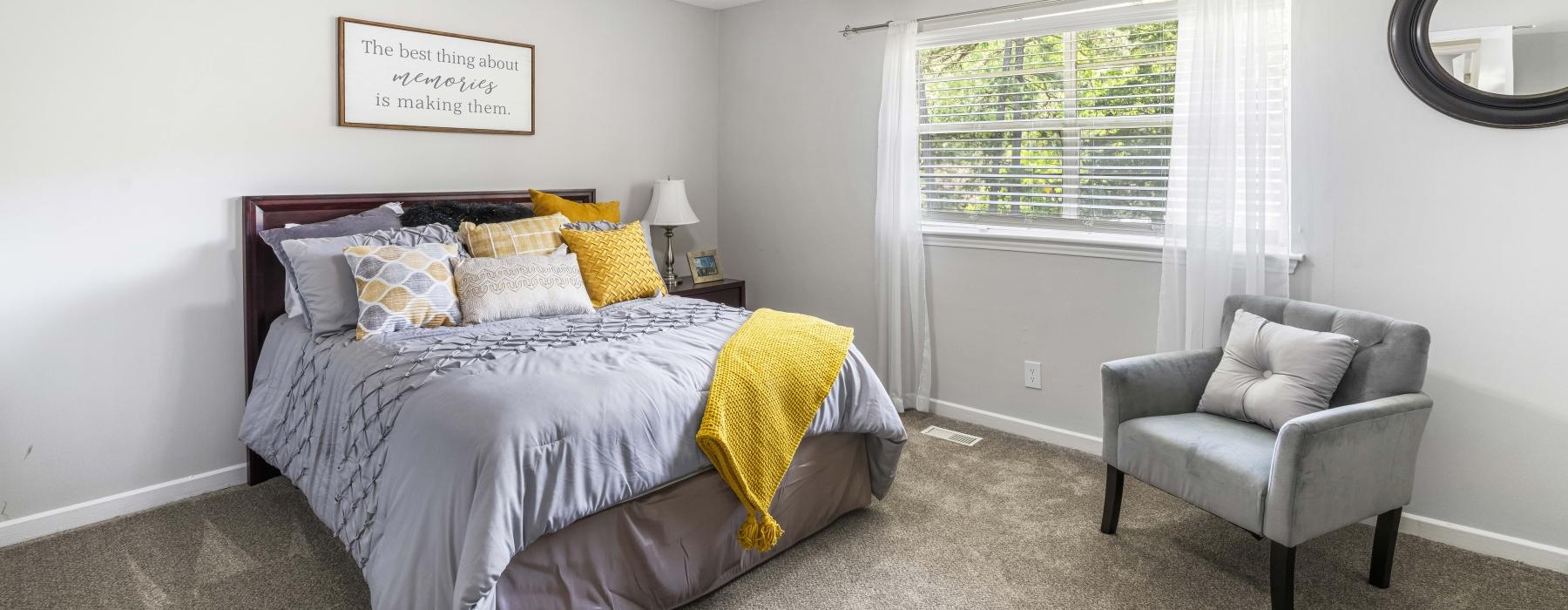 a bedroom with a bed and a fan