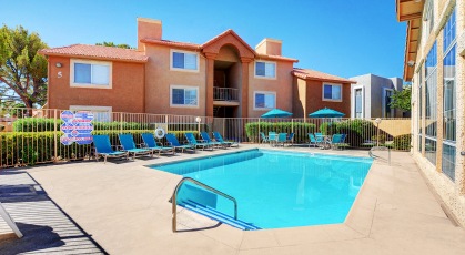 Swimming pool with lounge seating and umbrellas