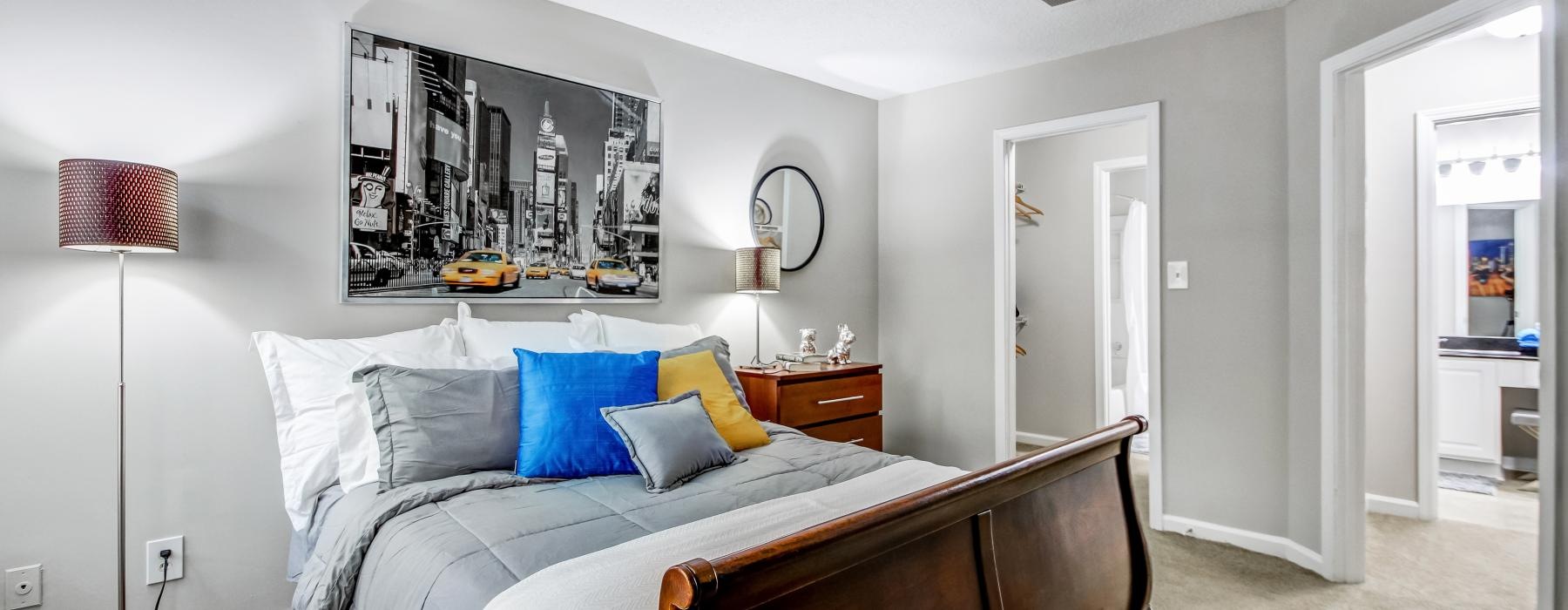 a bedroom with a bed and a lamp