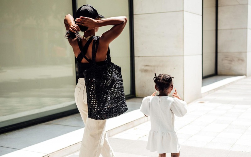 a woman walking with a child