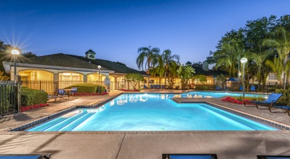 Swimming pool with lounge seating and umbrellas