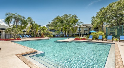 Swimming pool with lounge seating and umbrellas