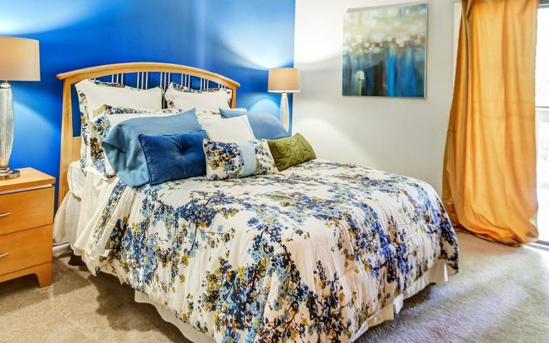 a bed with a blue and white comforter