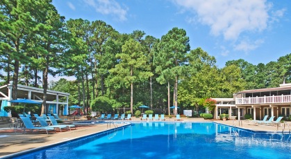 Swimming pool with lounge seating and umbrellas