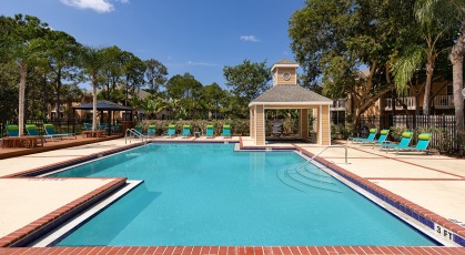 Swimming pool with lounge seating and umbrellas