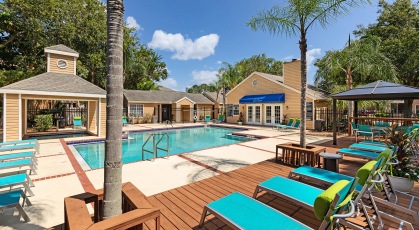 Swimming pool with lounge seating and umbrellas