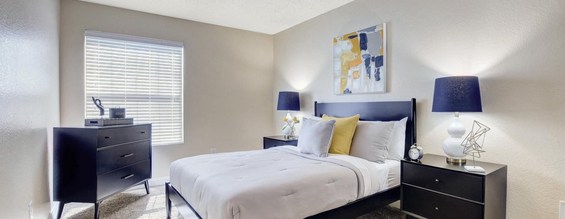 a bedroom with a bed and a dresser