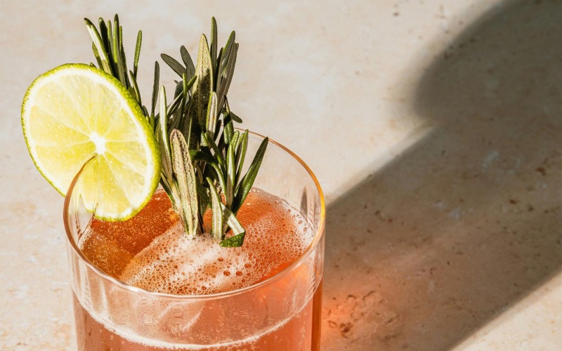 a glass with a drink and a lemon on top