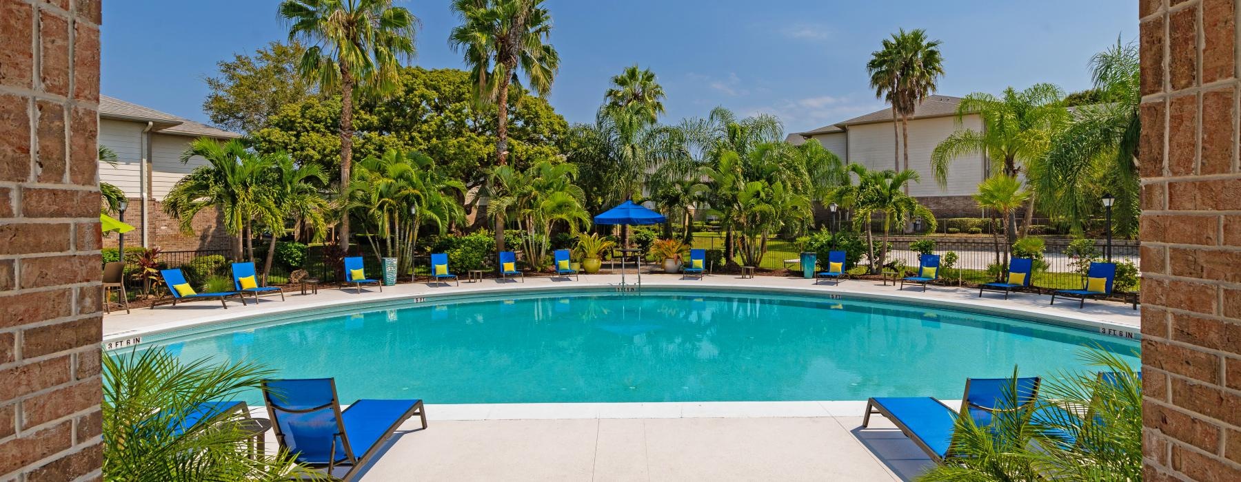 a pool with chairs and umbrellas