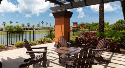 Pergola covered seating area overlooking pond
