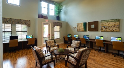 Spacious business center with computer stations and central seating area